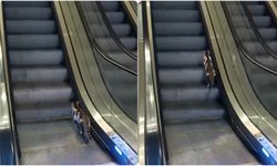 Yürüyen merdivene ters binen kedinin yardımına vatandaş koştu