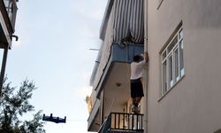 Evde çıkan yangında mahsur kalan kediyi balkona tırmanıp kurtardı