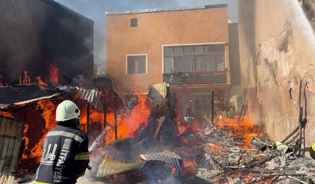 Alevlerin evine sıçramasını hortumla önlemeye çalıştı